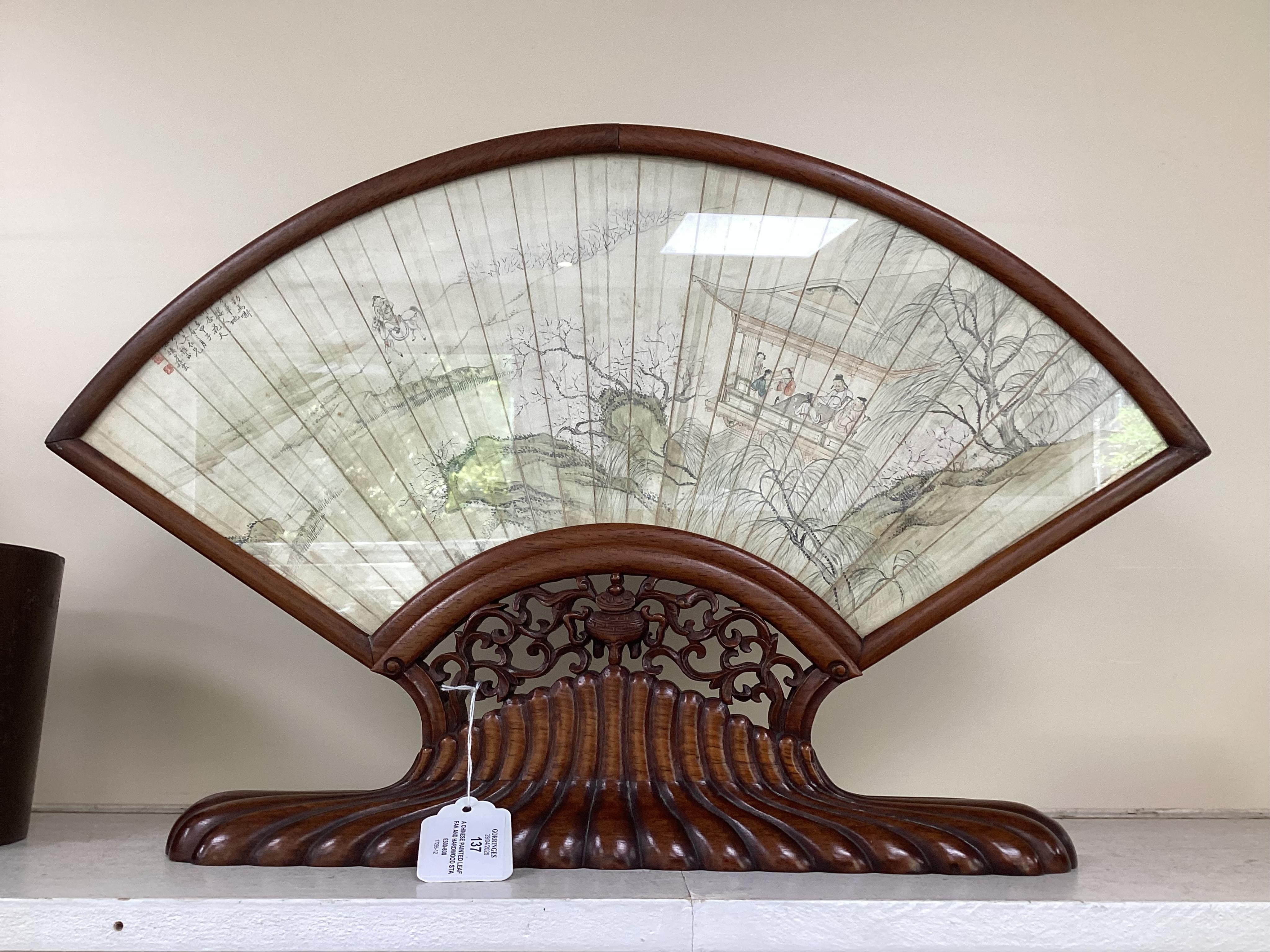 A Chinese painted leaf fan and hardwood stand, late 19th century